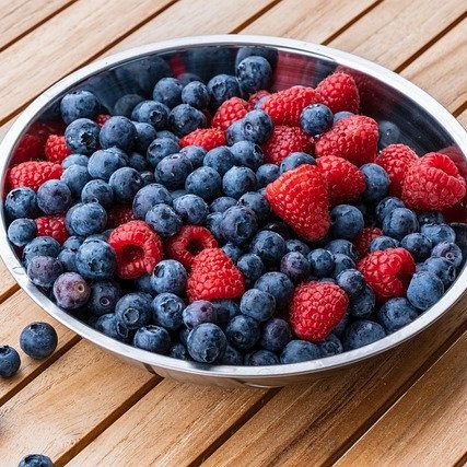Raspberries and blueberries in a bowl 